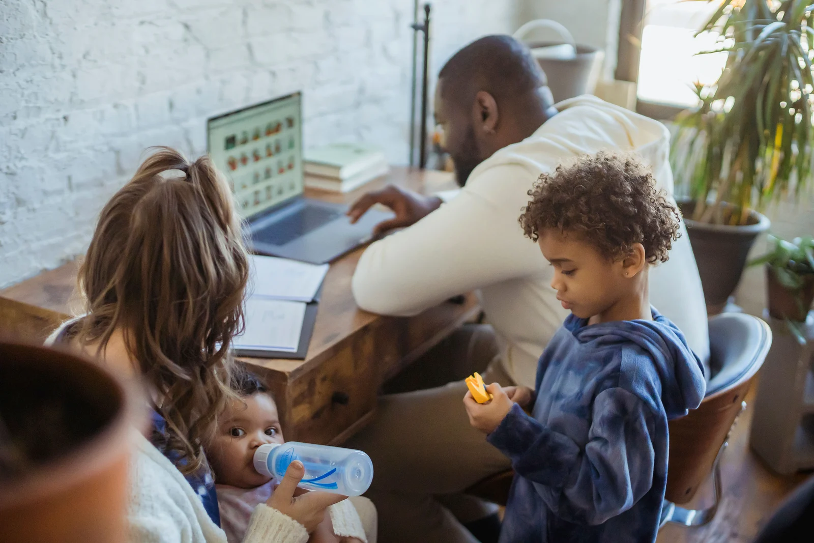 A parent working from home while children spend time nearby