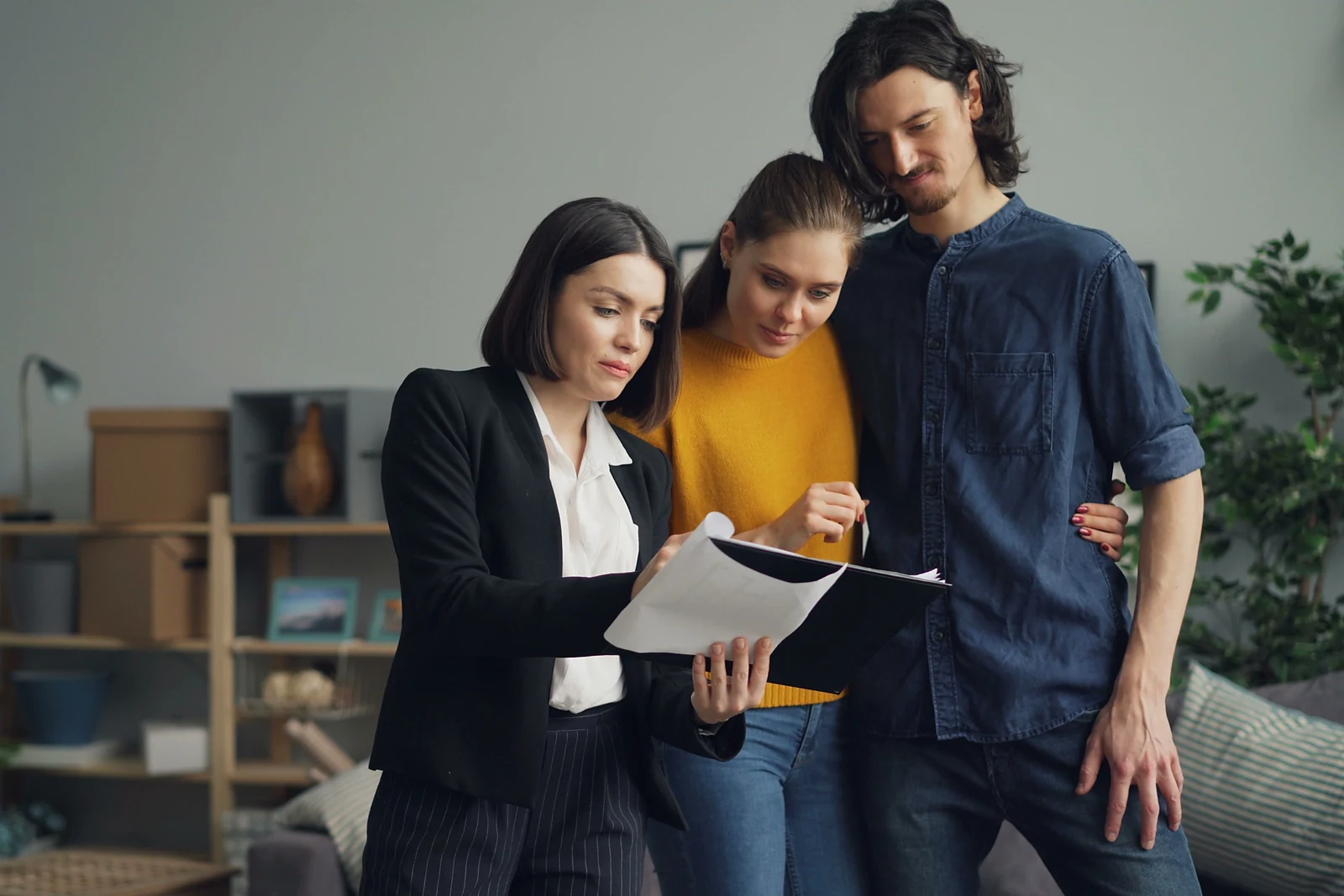 A couple reviewing property documents with a real estate professional