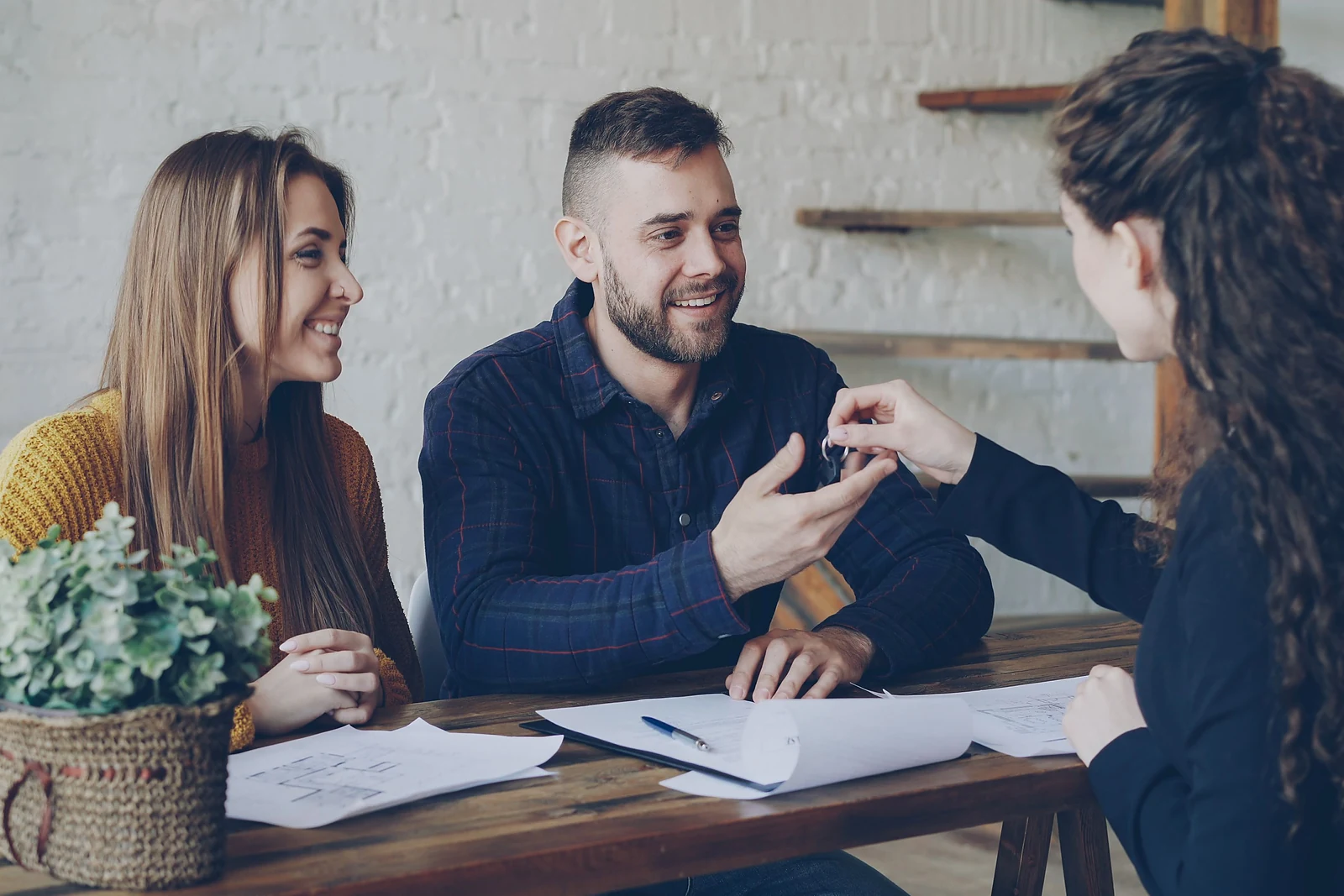 A homebuying couple receiving the keys to their new home
