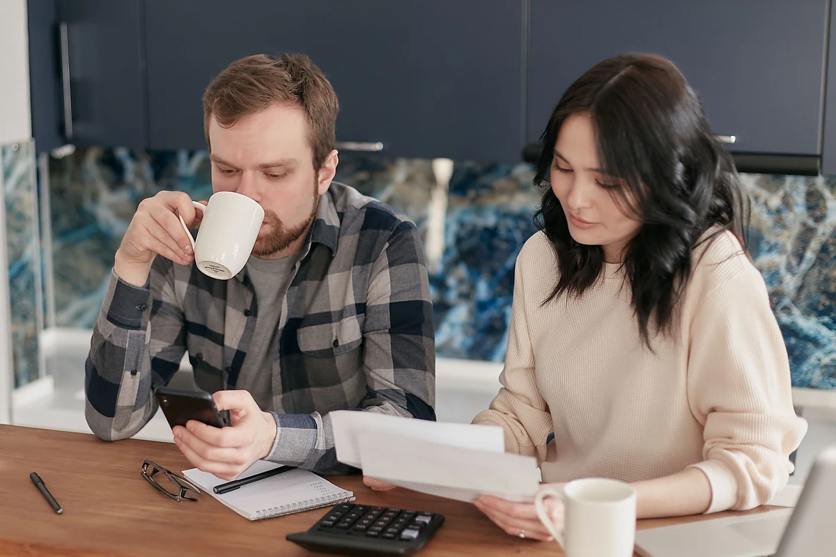 Homeowners reviewing their current mortgage costs and refinance options