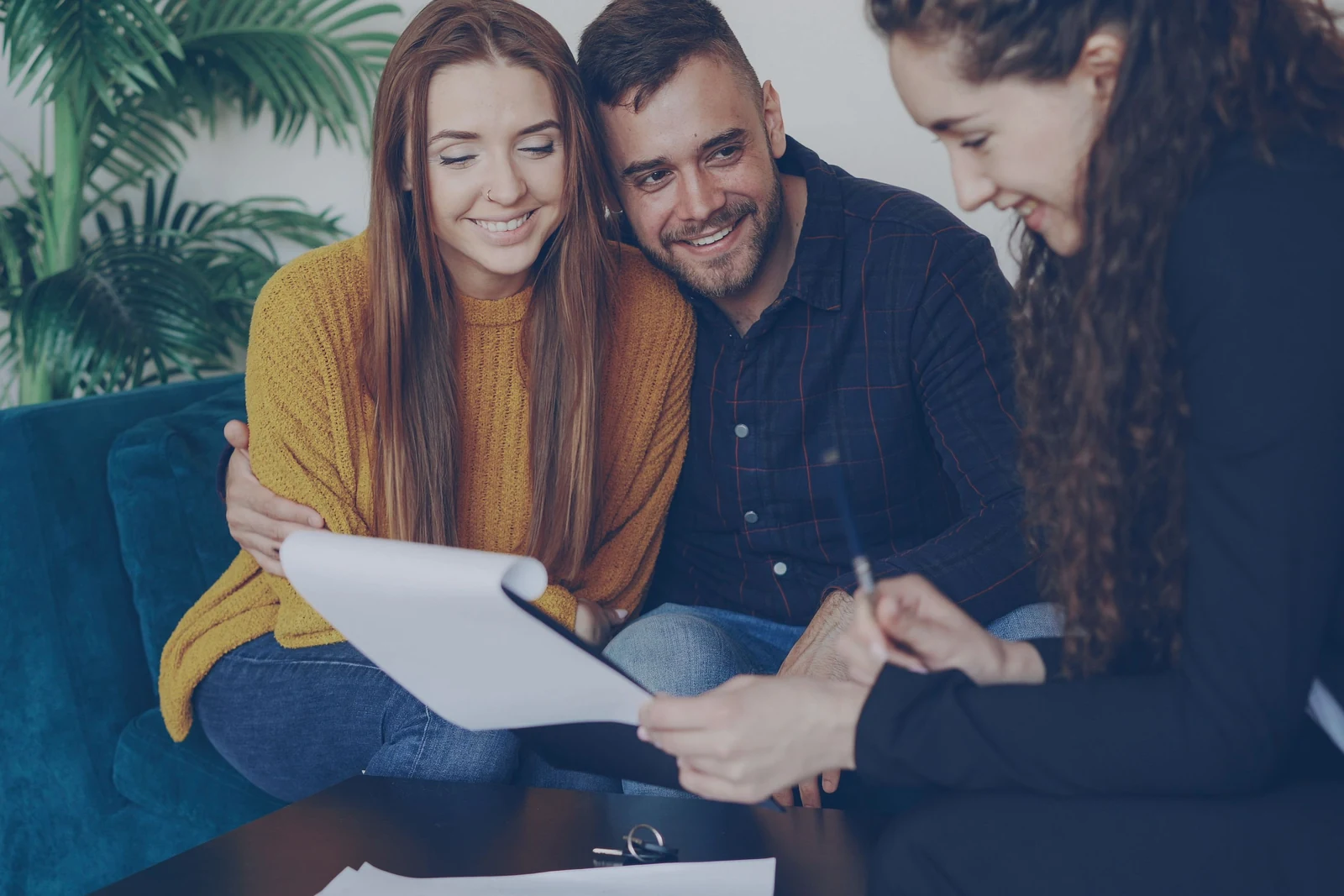 Homebuyers shaking hands with a real estate professional