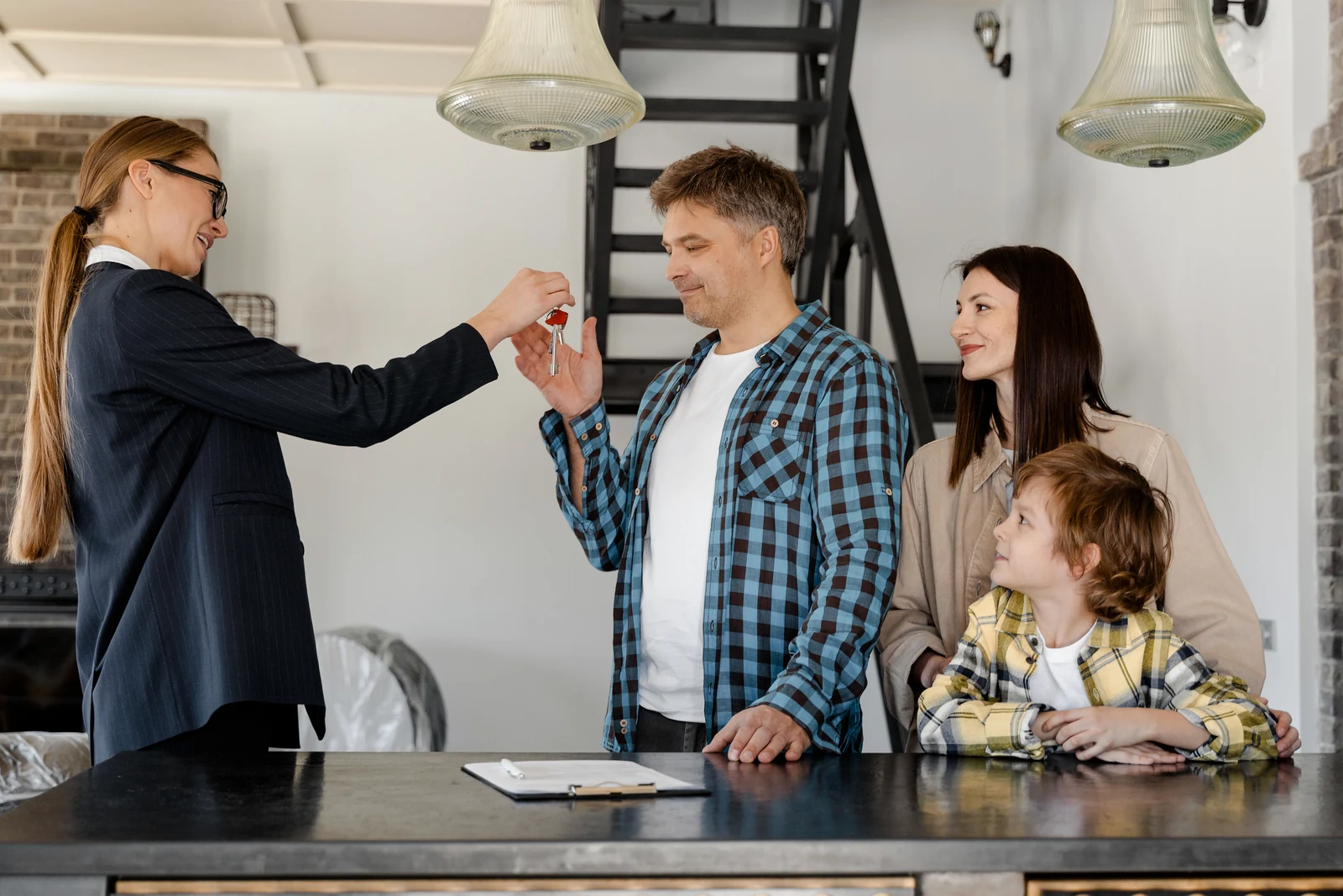 A family touring a home with a real estate professional