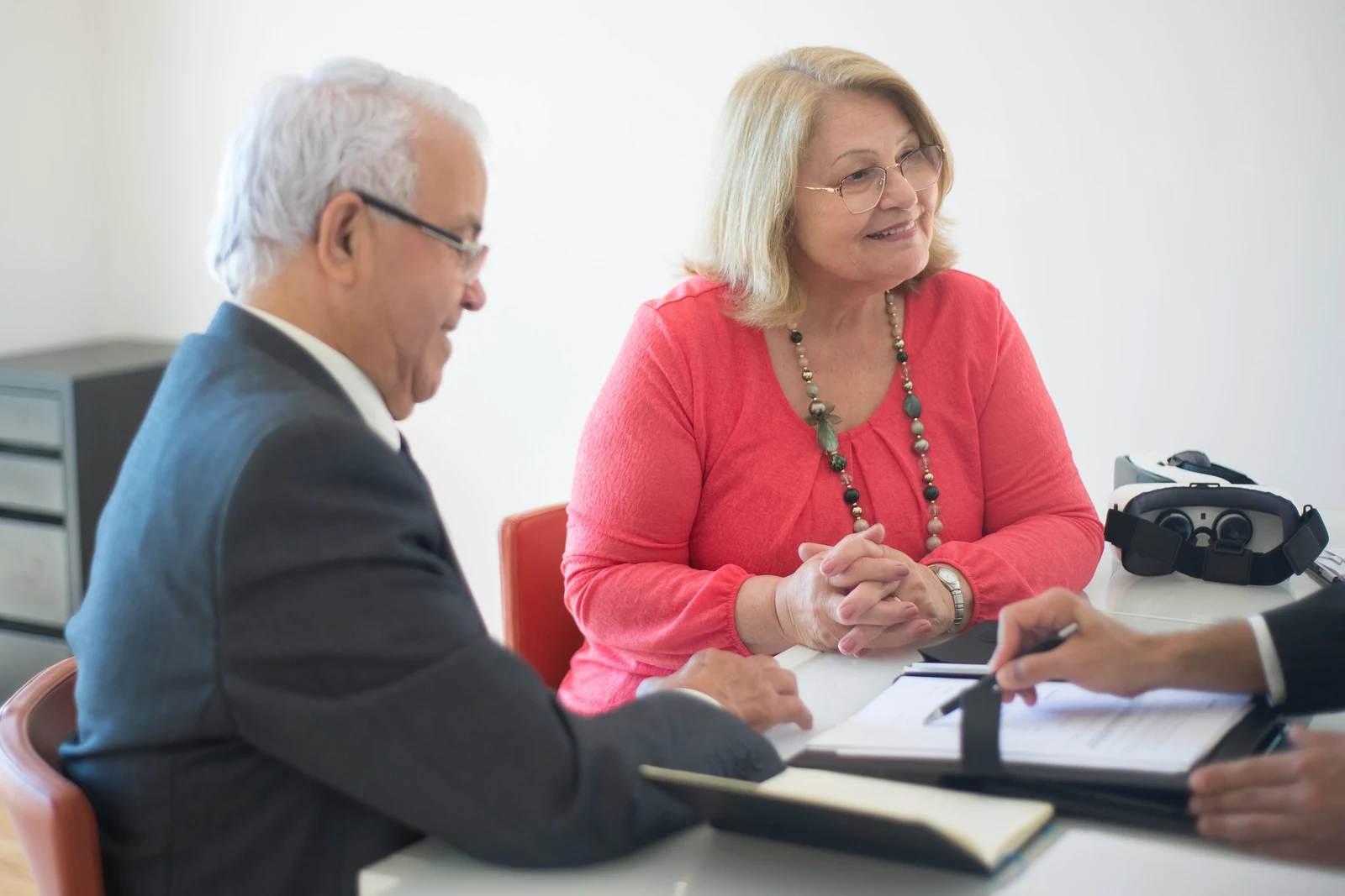 Older homeowners meeting with a trusted mortgage advisor